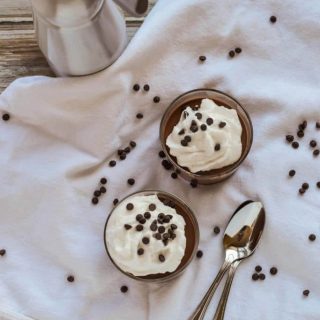 Two bowls of ice cream with chocolate chips and two ingredients.