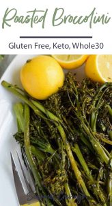 Roasted broccolini on a plate with lemons.