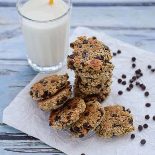 A stack of gluten free breakfast cookies with a glass of milk.