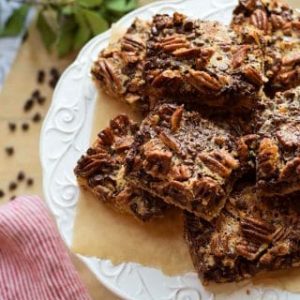 Gluten-free chocolate pecan bars on a white plate.