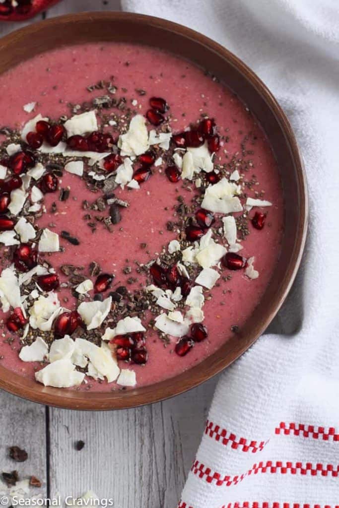 pomegranate smoothie bowl with coconut flakes