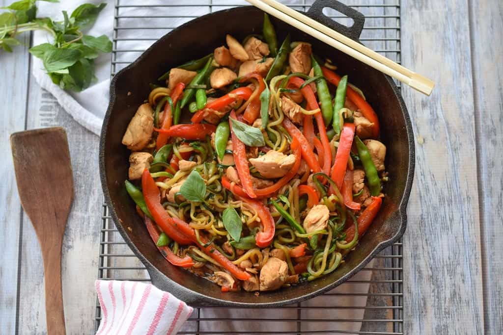 Chicken Thai Basil with Zucchini Noodles - Full of red peppers, sugar snap peas, stir fried chicken and a savory sauce over zucchini noodles.{gluten free, paleo, whole30}