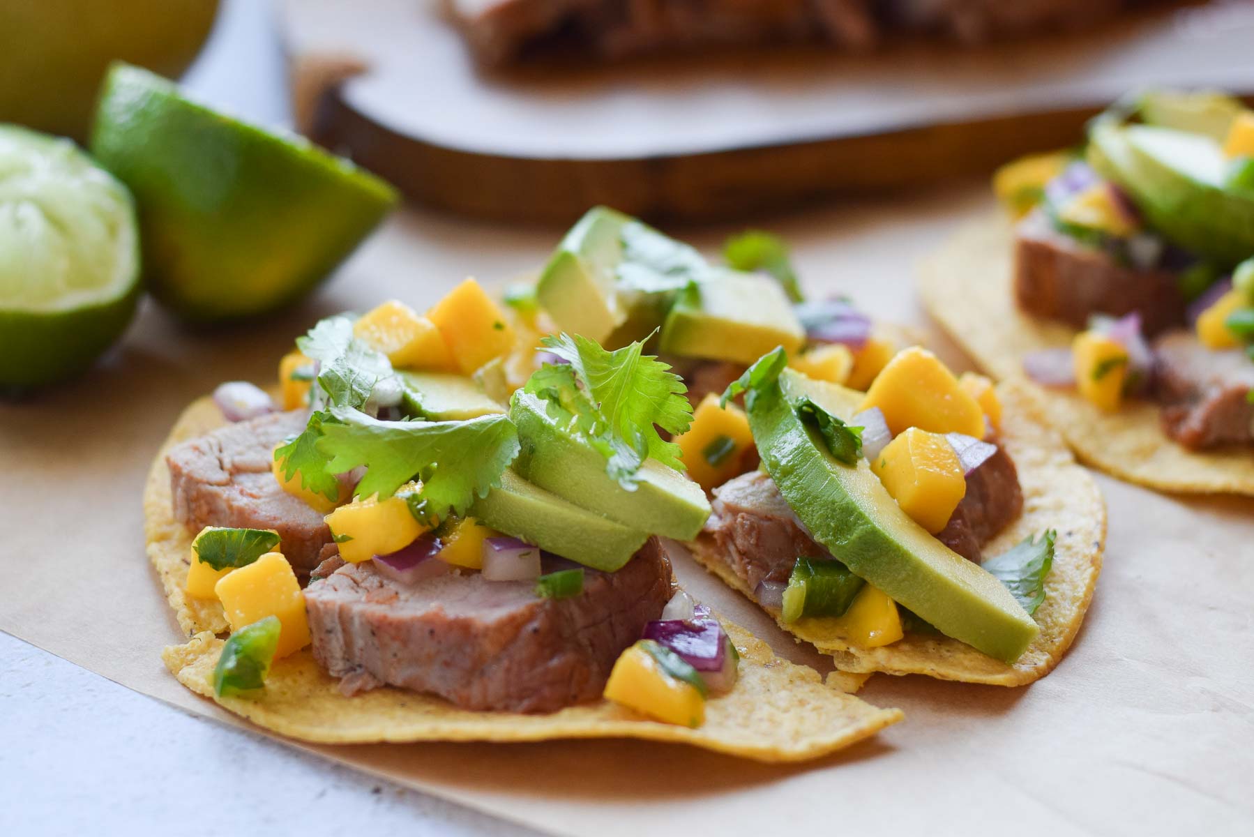 Pork Tostadas with Mango Salsa and limes.