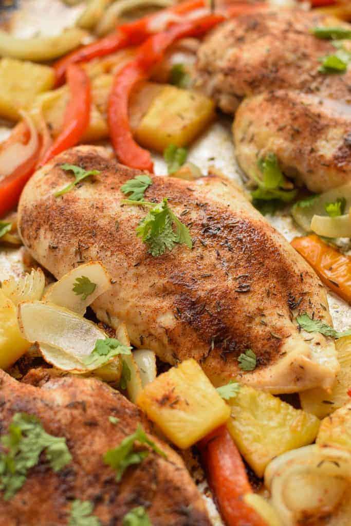 sheet pan jerk chicken close up with pineapple and peppers