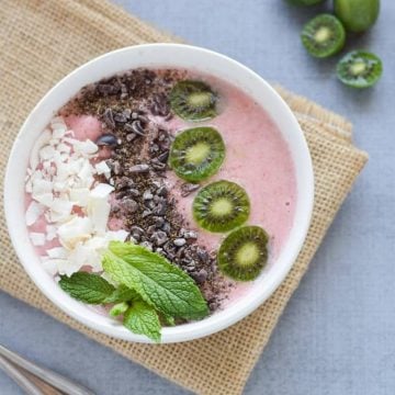 Strawberry Banana Smoothie Bowl in white bowl on brown burlap