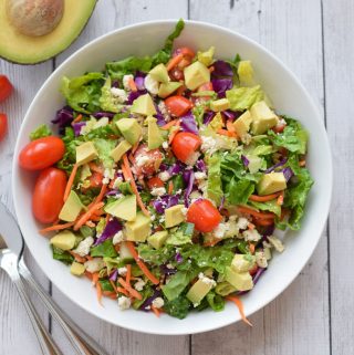 Healthy Chopped Sala with avocado in white bowl