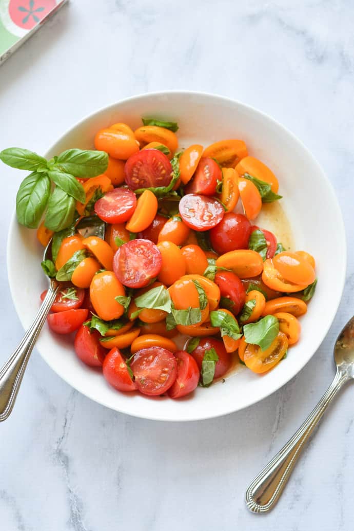 Marinated Tomato Basil Salad in a white bowl