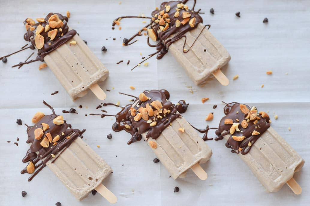 Chocolate Peanut Butter Banana Popsicles with chopped peanuts