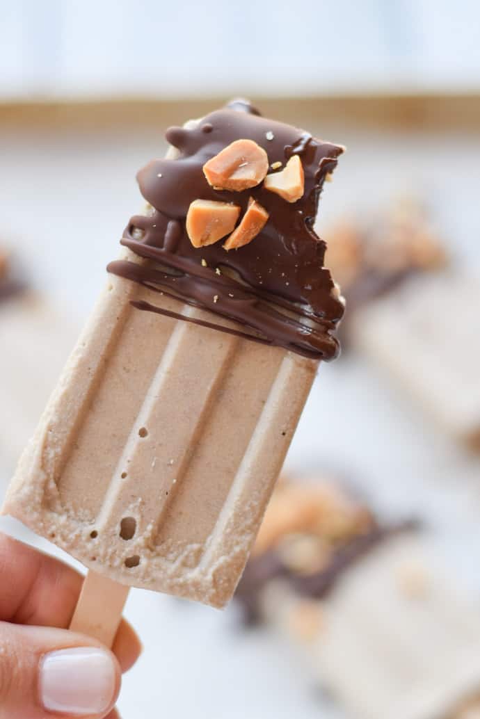 Chocolate Peanut Butter Banana Popsicles with a bite out 