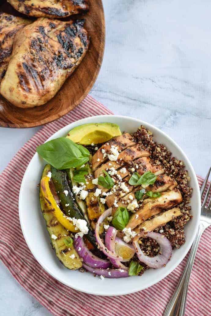 Healthy meal prep grilled chicken grain bowls in white bowl