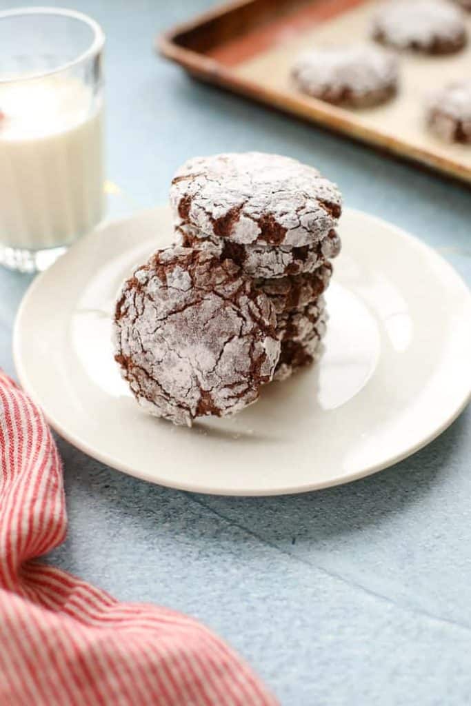 Chocolate Crinkle Cookies on a while plate stacked up