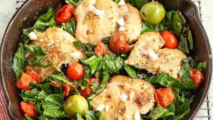 Mediterranean Skillet Chicken with Greens in a cast iron pan