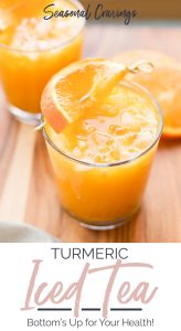A refreshing cup of turmeric iced tea with a slice of orange.