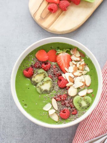Green Smoothie Bowl with Raspberries full of kale, kiwi and berries