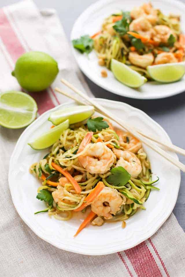 Zucchini Noodle Stir Fry with Shrimp on white plates with chopsticks