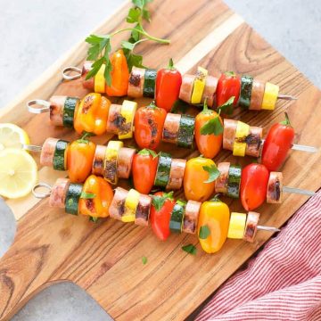 Chicken Sausage Skewers with Vegetables on skewers on a cutting board