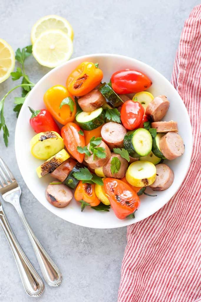 Chicken Sausage Skewers with Vegetables off the skewers in a white bowl