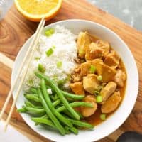 Instant Pot Orange Chicken with green beans in a white bowl