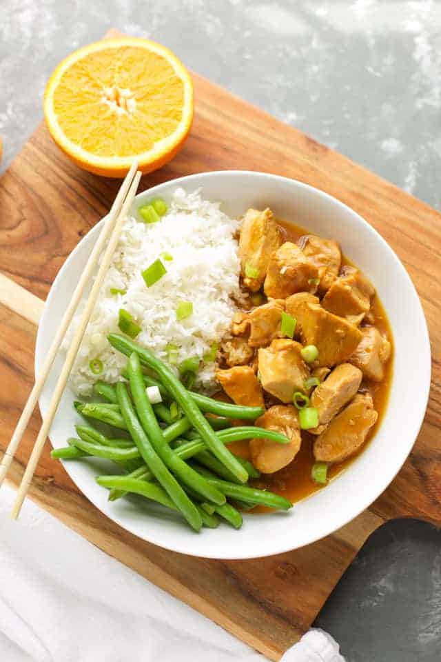 Instant Pot Orange Chicken with green beans in a white bowl