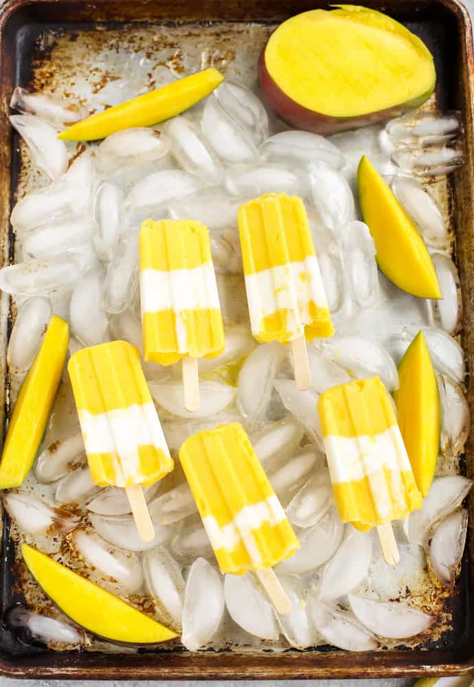 Mango popsicles on a tray of ice