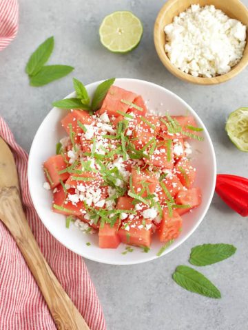 skinny watermelon feta salad in white bowl with mint