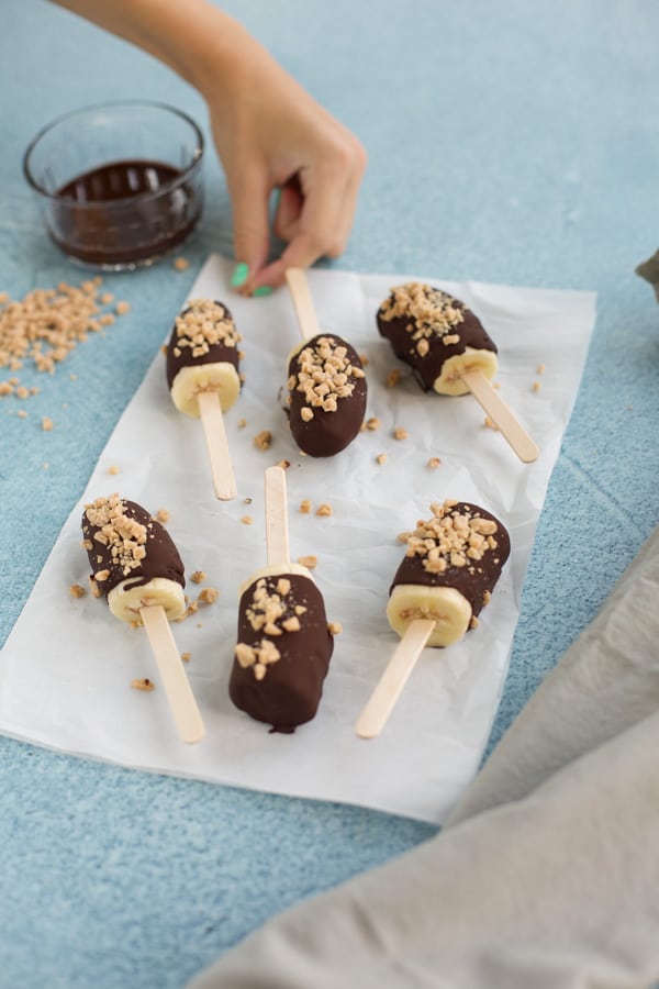 chocolate banana popsicles on parchment paper