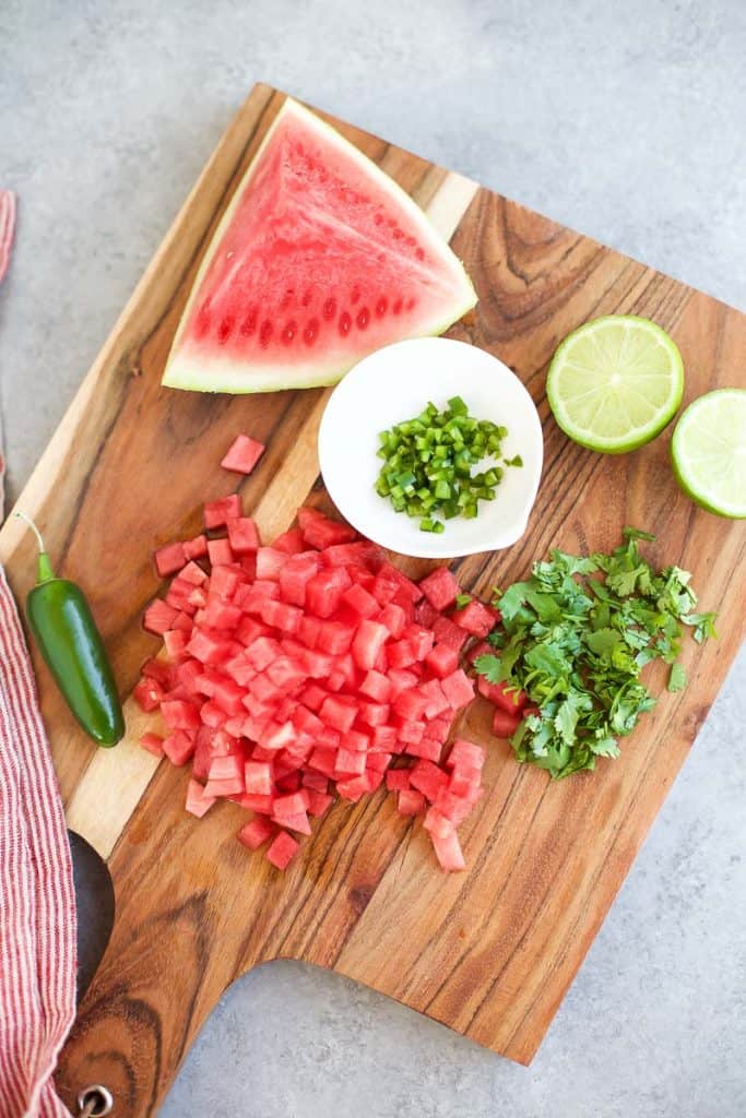 Grilled Skirt Steak with Watermelon Salsa ingredients on a cutting board