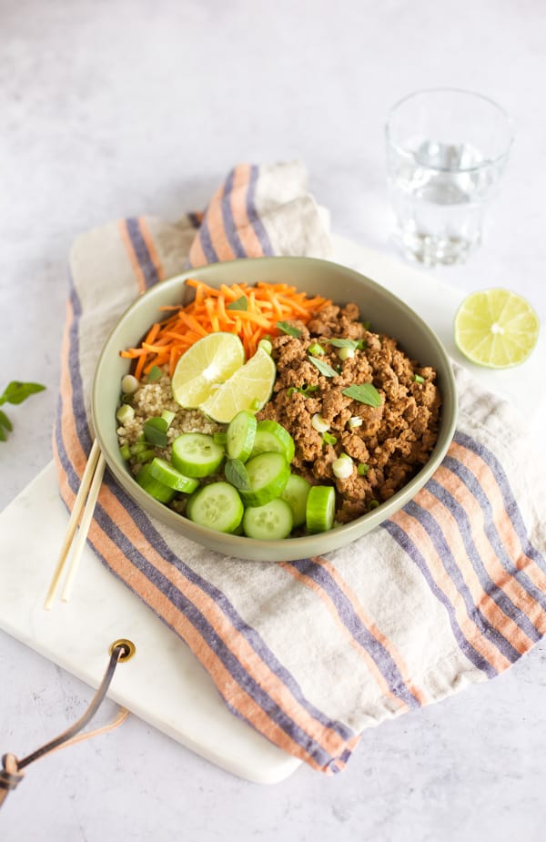 Indonesian beef and quinoa bowl with chopsticks and lime
