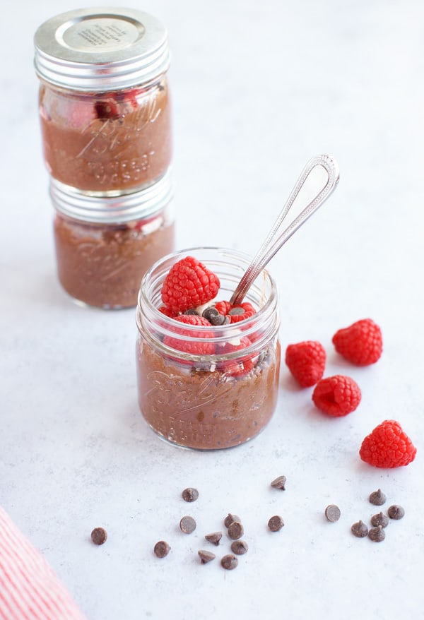 Chocolate chia pudding with raspberries and a spoon