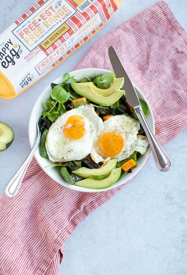 greens with fried eggs and avocado