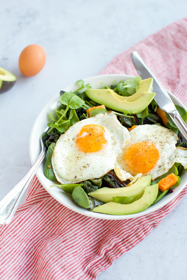 greens with eggs and avocado with fork