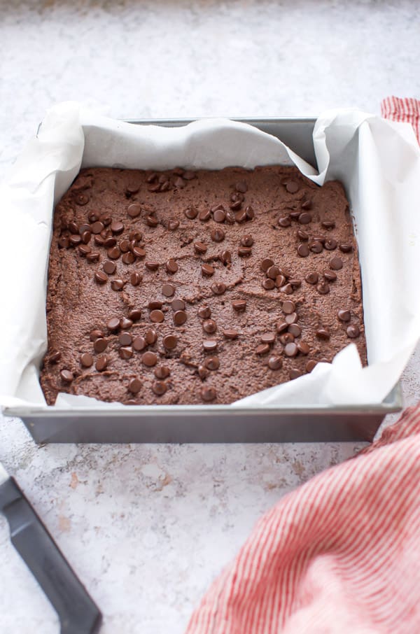  keto brownies with almond flour in baking pan lined with parchment paper