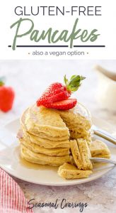 Gluten-free pancakes served with fresh strawberries on a plate.
