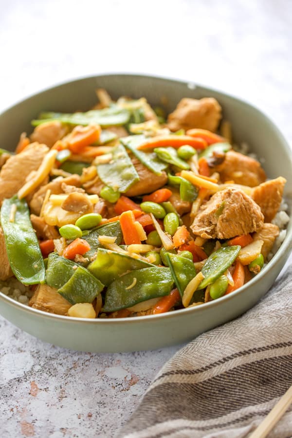 close up of chicken stir fry with snow peas and carrots