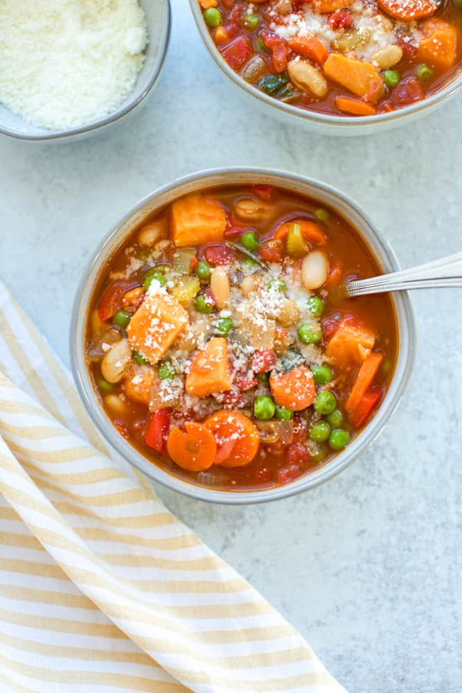 Minestrone Soup in a bowl with a spoon and a sprinkle of parmesan