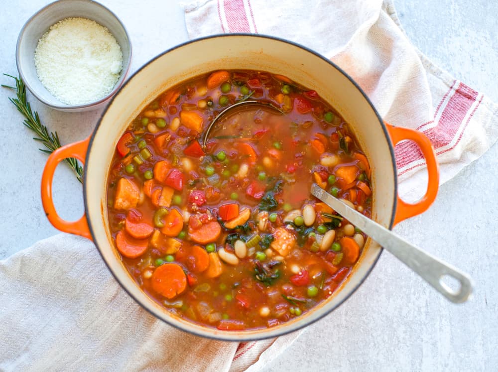 easy minestrone soup recipe in a dutch oven pot with ladle