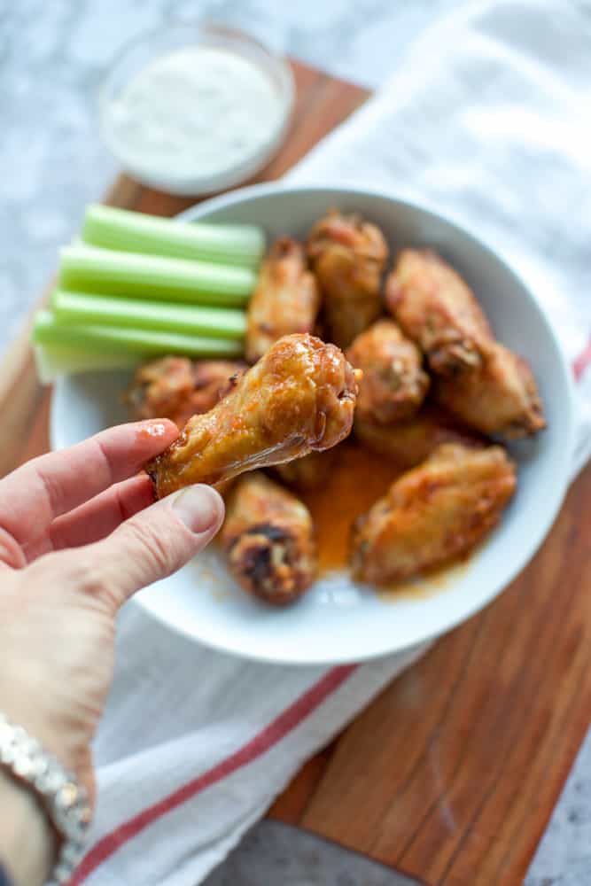 buffalo air fryer chicken wings in hand