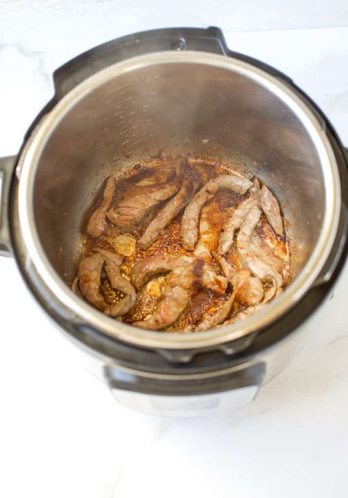 beef sauteing in an instant pot