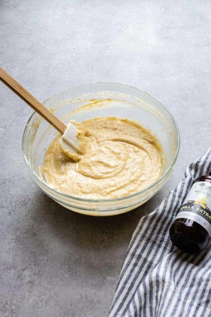 gluten free banana cake batter in a bowl with a spatula