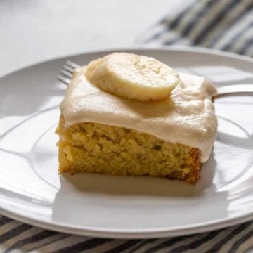 close up of banana cake with buttercream frosting