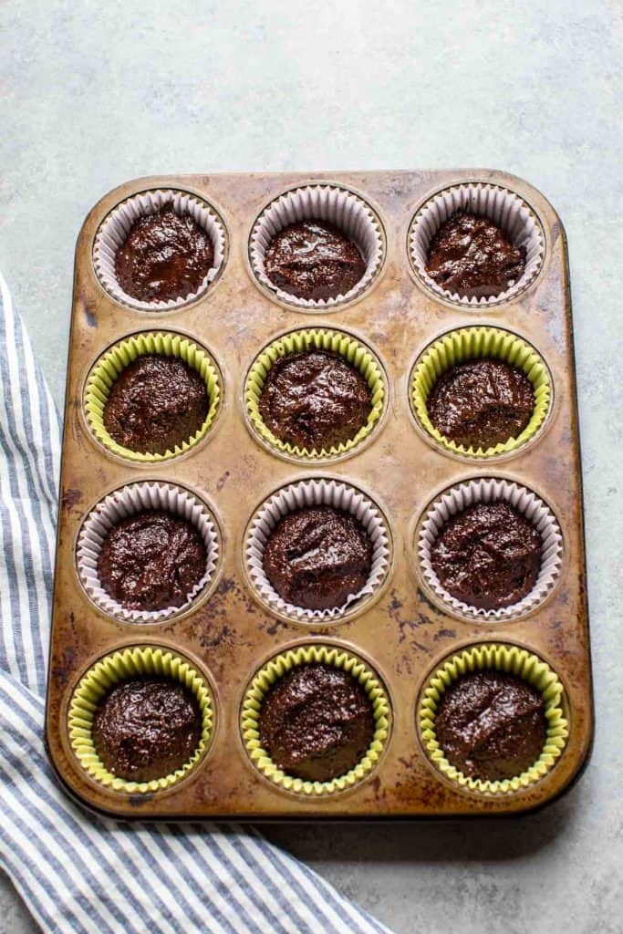 cupcake batter uncooked in muffin tins