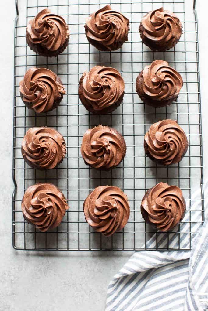 12 chocolate cupcakes on a cooling rack