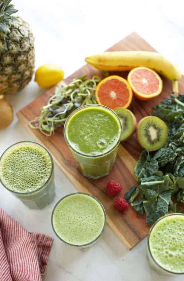 four green smoothies in glasses