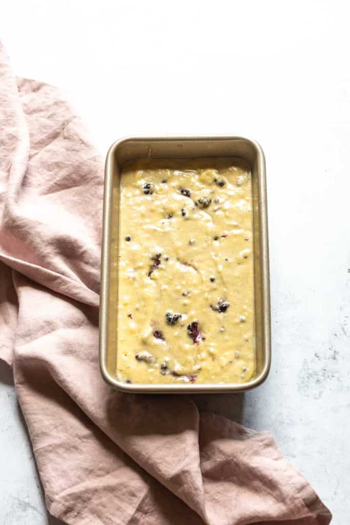 gluten free blackberry banana bread batter in a loaf pan