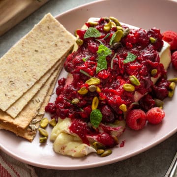 A plate of cranberry cheese with crackers.