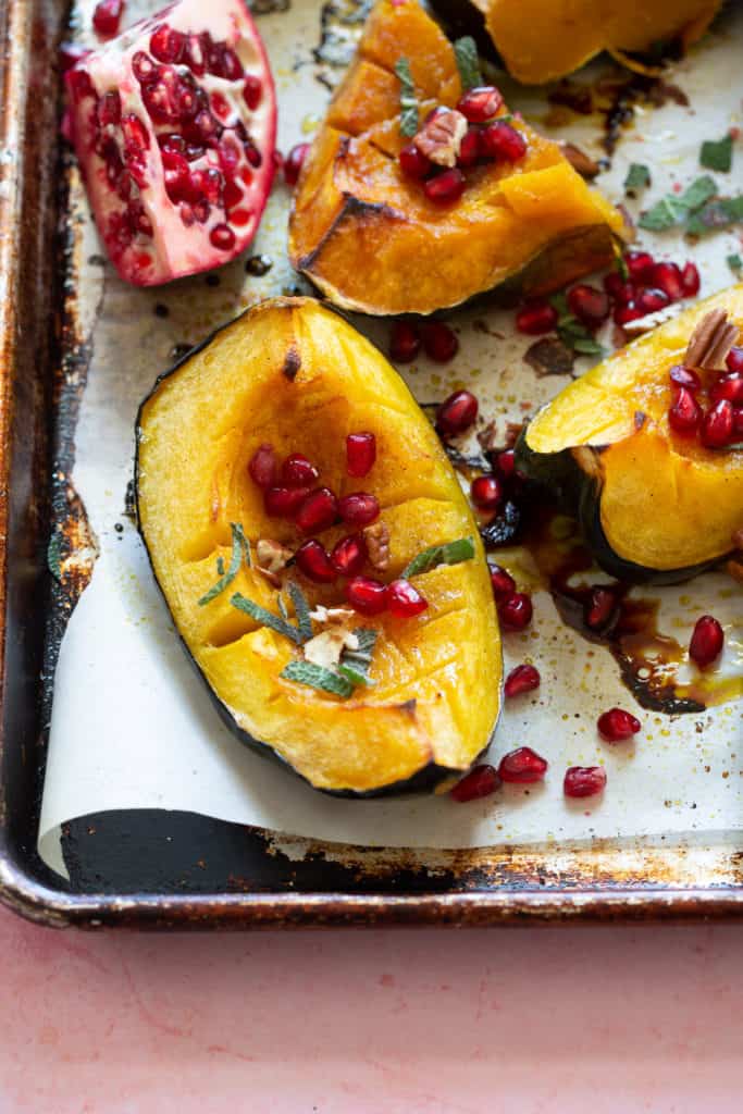 close up roasted acorn squash with butter and sage 