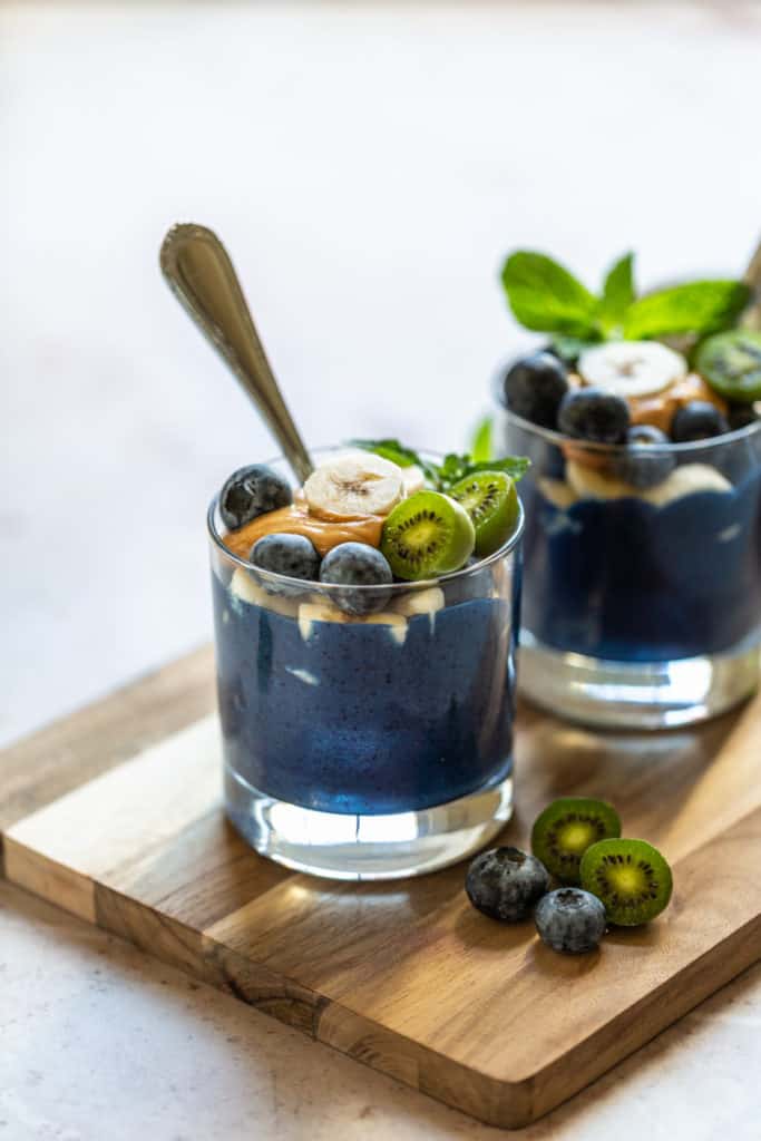 blueberry smoothie in glass with mint leaves