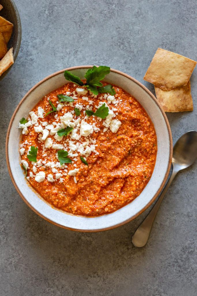 roasted red pepper dip with feta cheese in a bowl