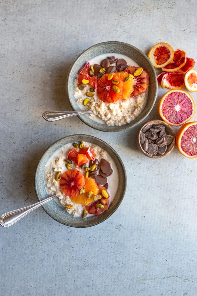 blood orange and chocolate oatmeal in two bowls with spoons