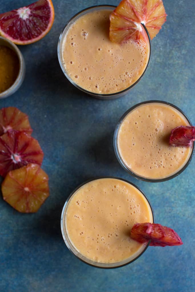 blood orange and turmeric smoothie in three glasses